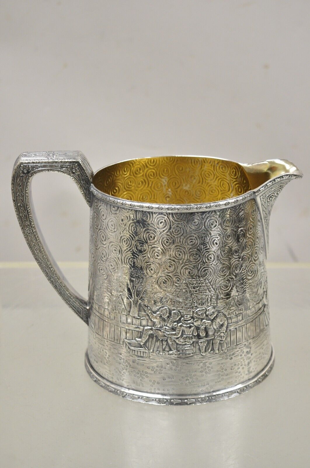 Derby S.P. Co International Figural Repousse Village Silverplate Water Pitcher