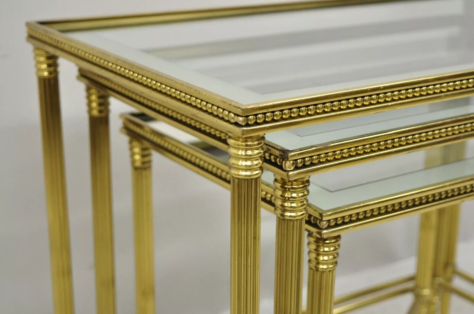 Italian Hollywood Regency Brass Mirror Glass Top Nesting Side Tables - Set 3