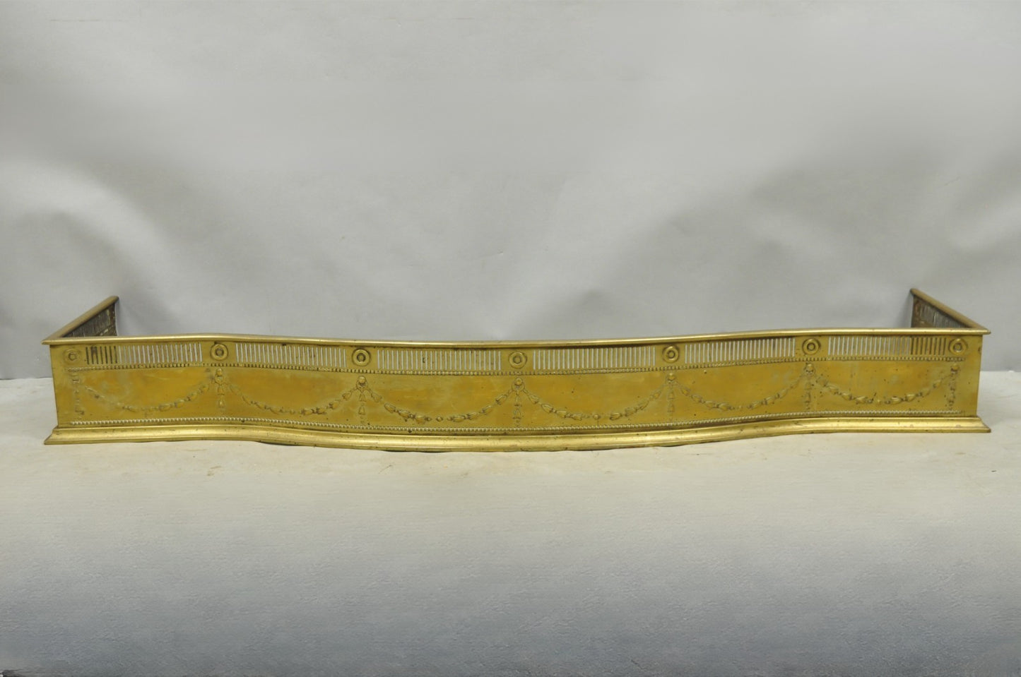 Antique English Victorian Serpentine Drape & Bellflower Brass Fireplace Fender