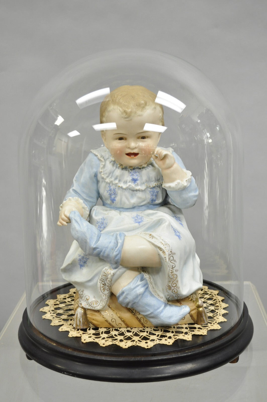 Antique Bisque Porcelain Seated Baby Figurine in Circular Glass Display Cloche