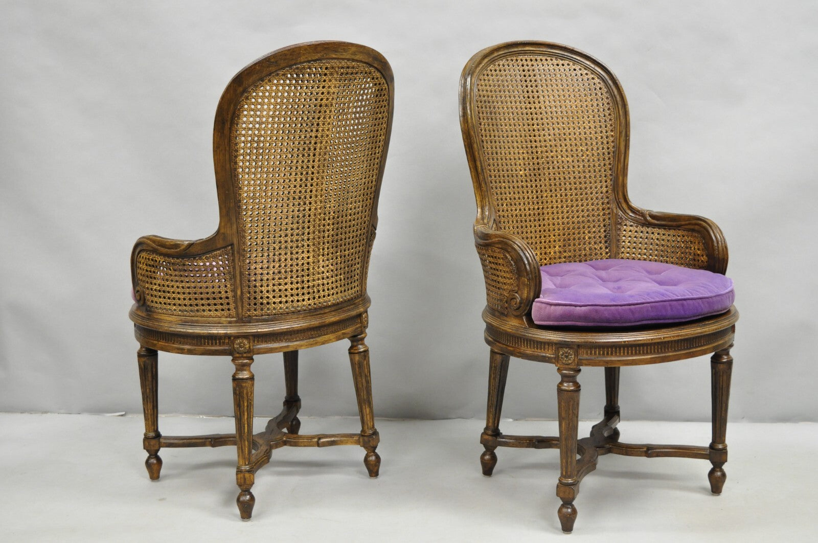 Vintage French Louis XVI Style Cane Balloon Back Walnut Arm Chairs - a Pair