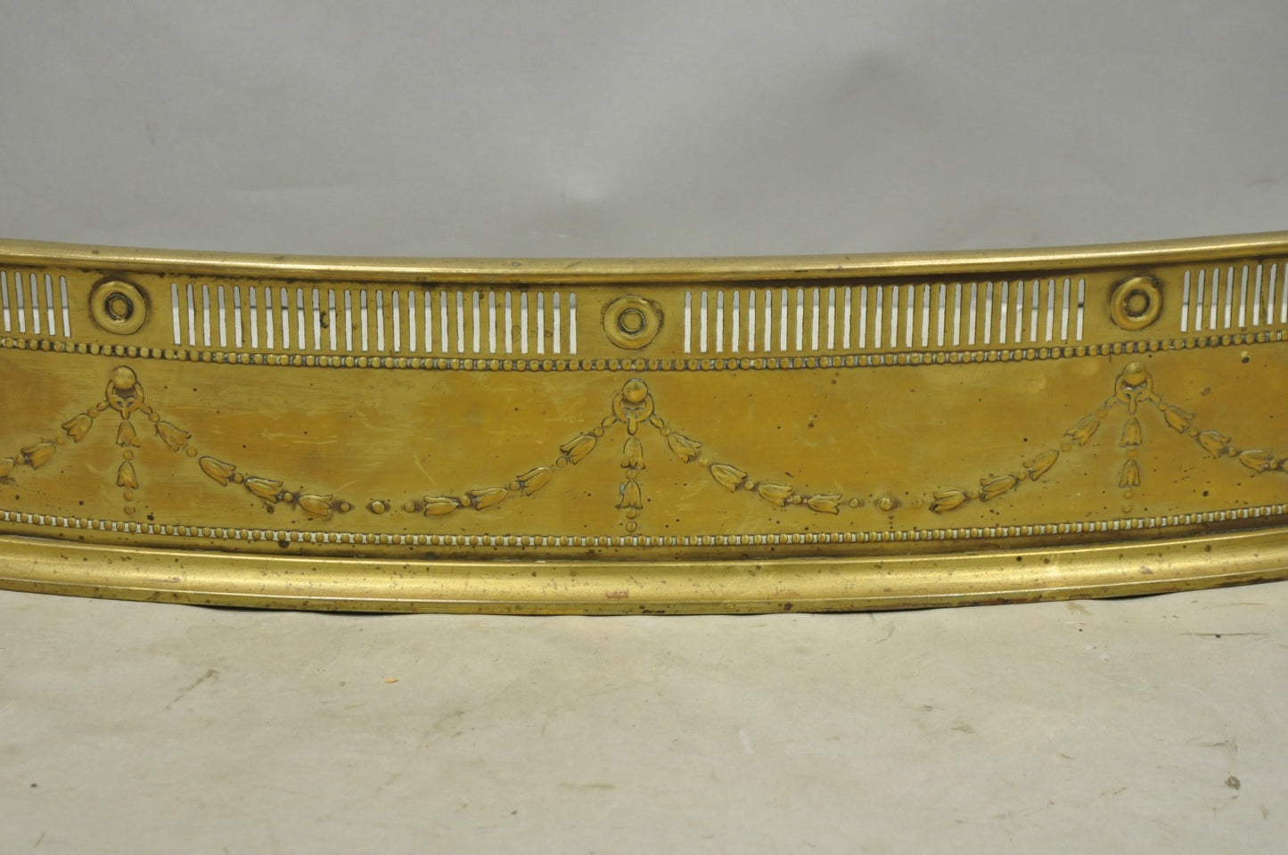 Antique English Victorian Serpentine Drape & Bellflower Brass Fireplace Fender