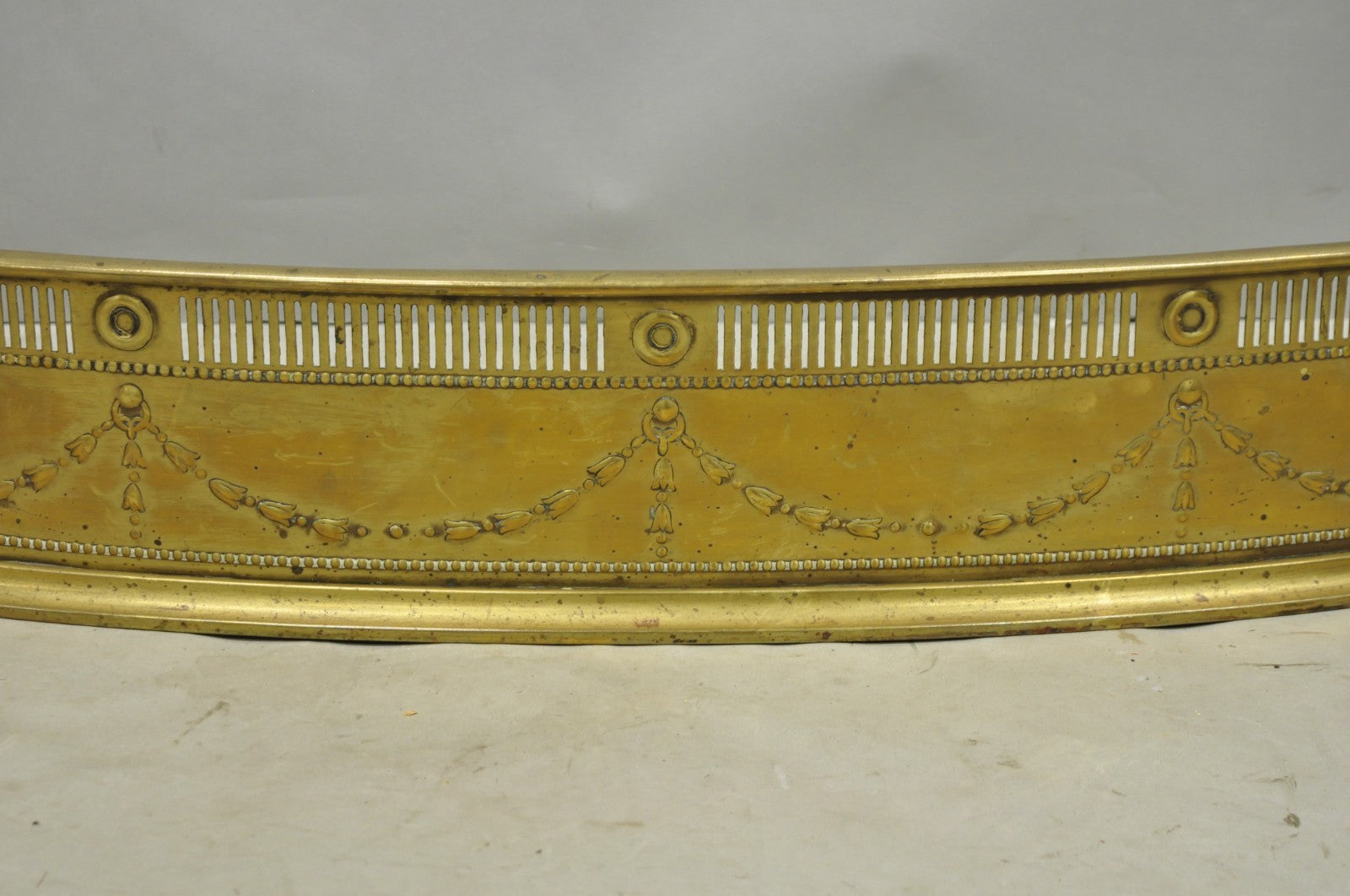 Antique English Victorian Serpentine Drape & Bellflower Brass Fireplace Fender