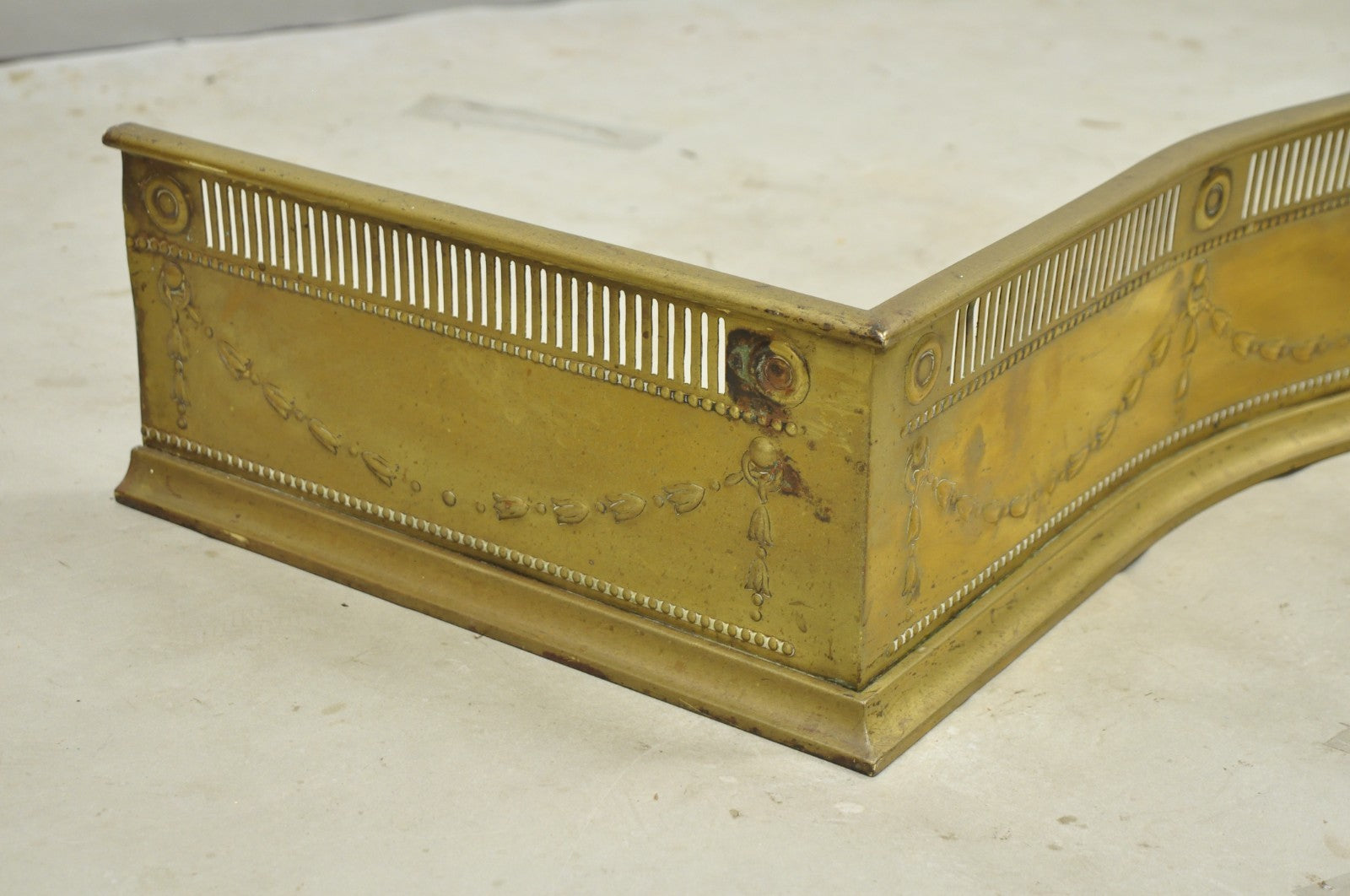 Antique English Victorian Serpentine Drape & Bellflower Brass Fireplace Fender