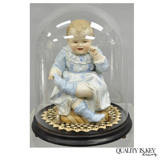 Antique Bisque Porcelain Seated Baby Figurine in Circular Glass Display Cloche